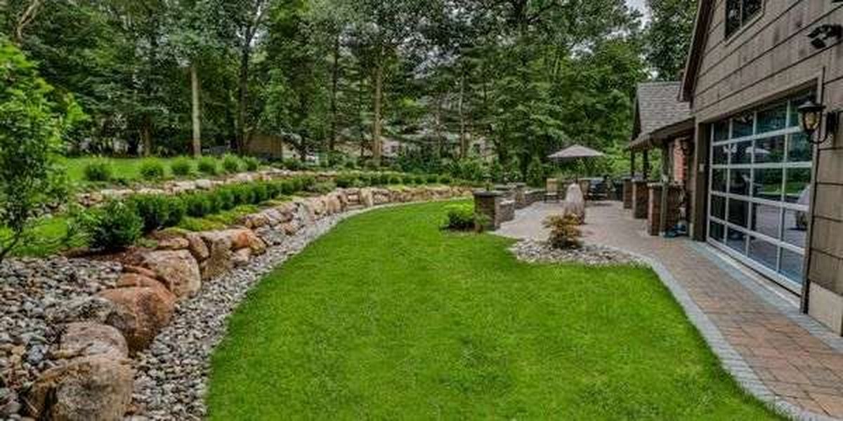 Lawn and retaining wall by Four Seasons Property Enhancements