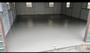Freshly poured concrete floor in metal barn building