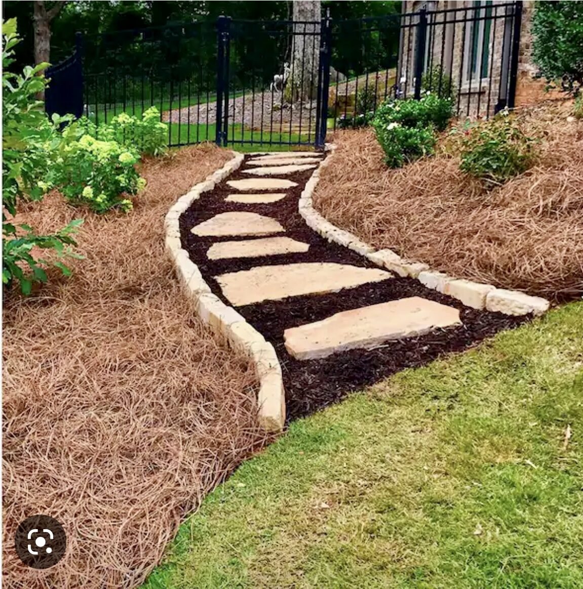 Stepping stone path through mulch bed with stone edging